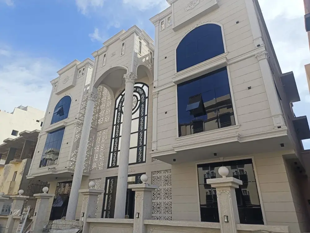 Villa facade with classic stone finishes and glass